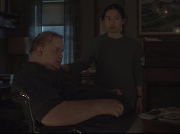 Movie still from “The Whale” (2022), directed by Darren Aronofsky – A man sitting in a wheelchair next to a woman; Medium shot, Over the shoulder angle