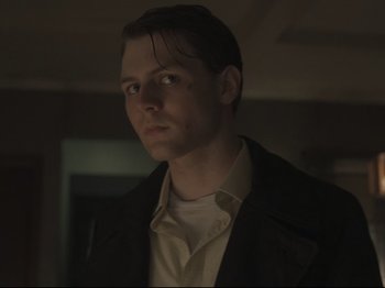 Movie still from “The Whale” (2022), directed by Darren Aronofsky – A man in a black jacket is looking at the camera; Close Up shot, Low angle