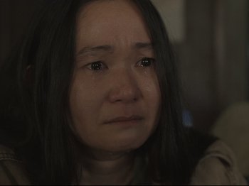 Movie still from “The Whale” (2022), directed by Darren Aronofsky – A person with a crying face; Close Up shot, High angle