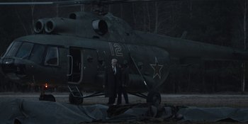 Movie still from “Chernobyl” (2019), directed by Johan Renck – Two men standing in front of an old helicopter; Wide shot, Low angle