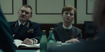 Movie still from “Chernobyl” (2019), directed by Johan Renck – Two people sitting in front of a table; Medium shot, Over the shoulder angle