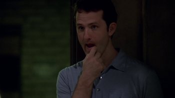 Movie still from “The Wire” (2002), created by David Simon – A man with his hand to his face looking to his left; Close Up shot, High angle