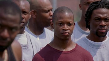 Movie still from “The Wire” (2002), created by David Simon – A group of men standing next to each other; Close Up shot, Low angle