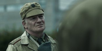 Movie still from “Chernobyl” (2019), directed by Johan Renck – An older man wearing a hat and a uniform; Close Up shot, Over the shoulder angle