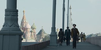 Movie still from “Chernobyl” (2019), directed by Johan Renck – A group of people walking across a bridge; Wide shot, Low angle
