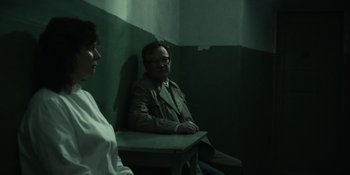 Movie still from “Chernobyl” (2019), directed by Johan Renck – A man and a woman sitting on a table; Medium shot, Over the shoulder angle