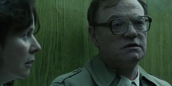 Movie still from “Chernobyl” (2019), directed by Johan Renck – A person wearing glasses; Close Up shot, Over the shoulder angle