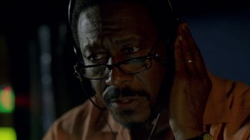 Movie still from “The Wire” (2002), created by David Simon – A person wearing headphones; Close Up shot, Low angle