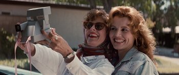 Movie still from “Thelma & Louise” (1991), directed by Ridley Scott – A couple of people that are posing for a picture; Close Up shot, Low angle