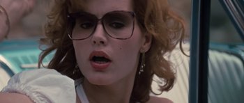 Movie still from “Thelma & Louise” (1991), directed by Ridley Scott – A person wearing glasses and looking at the camera; Close Up shot, Low angle