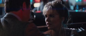 Movie still from “Thelma & Louise” (1991), directed by Ridley Scott – A woman sitting in a car looking at a cell phone; Close Up shot, Over the shoulder angle