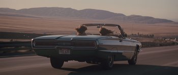 Movie still from “Thelma & Louise” (1991), directed by Ridley Scott – Two people in a convertible driving down a road; Wide shot, High angle