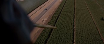Movie still from “Thelma & Louise” (1991), directed by Ridley Scott – An aerial view of a car driving down a road; Extreme Wide shot, High angle