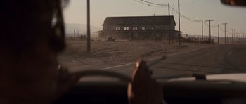 Movie still from “Thelma & Louise” (1991), directed by Ridley Scott – A view from a car of a house in the distance; Extreme Wide shot, Over the shoulder angle