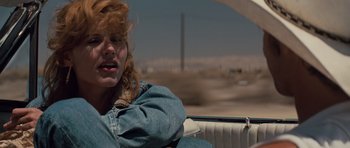 Movie still from “Thelma & Louise” (1991), directed by Ridley Scott – A woman sitting in the back of a car; Close Up shot, Low angle