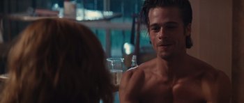 Movie still from “Thelma & Louise” (1991), directed by Ridley Scott – A man sitting in front of a woman in front of a window; Medium shot, Over the shoulder angle