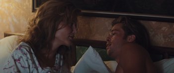 Movie still from “Thelma & Louise” (1991), directed by Ridley Scott – A man and a woman in a bed with a pillow; Medium shot, Over the shoulder angle