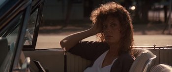 Movie still from “Thelma & Louise” (1991), directed by Ridley Scott – A woman sitting in a car with her hand on her head; Close Up shot, Low angle