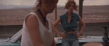 Movie still from “Thelma & Louise” (1991), directed by Ridley Scott – Two women standing next to each other in a desert setting; Medium shot, Low angle