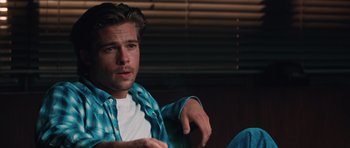 Movie still from “Thelma & Louise” (1991), directed by Ridley Scott – A man sitting in front of a window wearing a blue shirt; Close Up shot, Over the shoulder angle