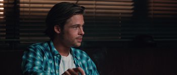 Movie still from “Thelma & Louise” (1991), directed by Ridley Scott – A man with long black hair wearing a blue shirt; Close Up shot, Over the shoulder angle