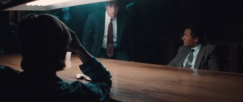 Movie still from “Thelma & Louise” (1991), directed by Ridley Scott – A man sitting at a table in front of a mirror; Medium shot, Over the shoulder angle