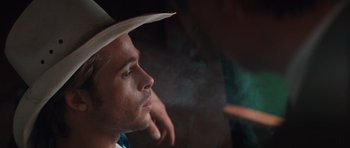 Movie still from “Thelma & Louise” (1991), directed by Ridley Scott – A person wearing a hat smoking a cigarette; Close Up shot, Over the shoulder angle