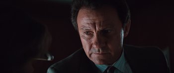 Movie still from “Thelma & Louise” (1991), directed by Ridley Scott – A person wearing a suit and tie; Close Up shot, Low angle