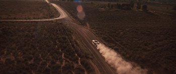 Movie still from “Thelma & Louise” (1991), directed by Ridley Scott – An aerial view of a car driving down a road; Extreme Wide shot, High angle