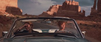 Movie still from “Thelma & Louise” (1991), directed by Ridley Scott – Two people in a car on the side of the road; Wide shot, Low angle