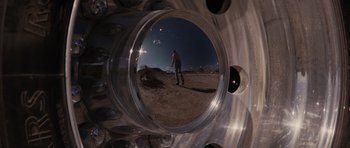 Movie still from “Thelma & Louise” (1991), directed by Ridley Scott – A man standing on top of a sandy beach at night; Wide shot, Overhead angle