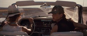 Movie still from “Thelma & Louise” (1991), directed by Ridley Scott – A man driving a car with a woman sitting in the driver's seat; Medium shot, Low angle