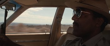 Movie still from “Thelma & Louise” (1991), directed by Ridley Scott – A man sitting in the driver's seat of a car; Close Up shot, Over the shoulder angle
