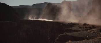 Movie still from “Thelma & Louise” (1991), directed by Ridley Scott – A car is driving on the side of a cliff; Extreme Wide shot, Low angle