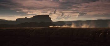 Movie still from “Thelma & Louise” (1991), directed by Ridley Scott – A dirt field with a mountain in the background; Extreme Wide shot, Low angle