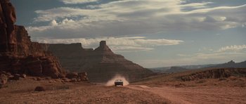Movie still from “Thelma & Louise” (1991), directed by Ridley Scott – A truck driving down a dirt road in the desert; Extreme Wide shot, Low angle