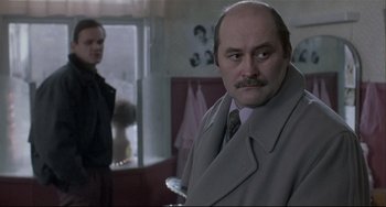 Movie still from “Three Colors: White” (1994), directed by Krzysztof Kieslowski – Close Up shot, Over the shoulder angle