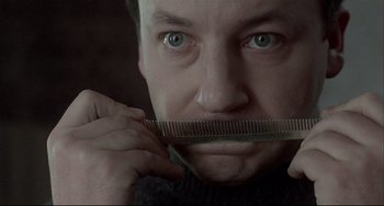 Movie still from “Three Colors: White” (1994), directed by Krzysztof Kieslowski – Close Up shot, Low angle