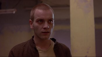 Movie still from “Trainspotting” (1996), directed by Danny Boyle – A person wearing a brown jacket; Close Up shot, Low angle