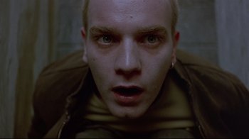 Movie still from “Trainspotting” (1996), directed by Danny Boyle – A man's face in a dark room; Close Up shot, Overhead angle