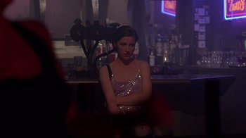 Movie still from “Trainspotting” (1996), directed by Danny Boyle – A woman sitting at a table in front of a bar; Medium shot, Over the shoulder angle