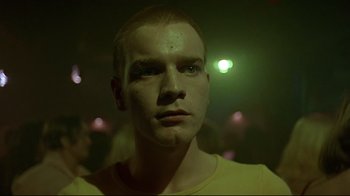 Movie still from “Trainspotting” (1996), directed by Danny Boyle – A person wearing a yellow t - shirt; Close Up shot, Low angle