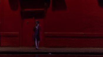 Movie still from “Trainspotting” (1996), directed by Danny Boyle – A woman standing on the side of the street; Extreme Wide shot, Low angle