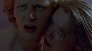 Movie still from “Trainspotting” (1996), directed by Danny Boyle – A man and a woman face to face in the dark; Close Up shot, Low angle