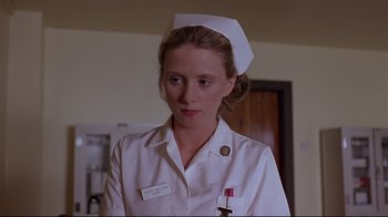 Movie still from “Trainspotting” (1996), directed by Danny Boyle – A woman in a nurse's uniform is looking at the camera; Close Up shot, Low angle