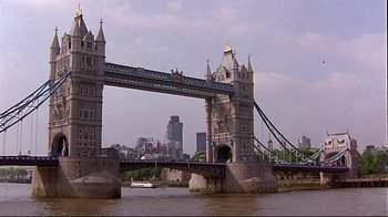 Movie still from “Trainspotting” (1996), directed by Danny Boyle – A view of a bridge that is over a body of water; Extreme Wide shot, Low angle