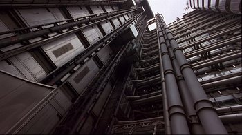 Movie still from “Trainspotting” (1996), directed by Danny Boyle – Looking up at a tall building from the ground up; Extreme Wide shot, Low angle