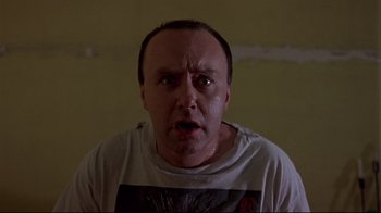 Movie still from “Trainspotting” (1996), directed by Danny Boyle – A person wearing a t - shirt; Close Up shot, Low angle