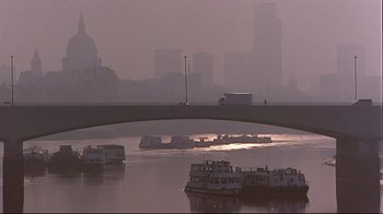 Movie still from “Trainspotting” (1996), directed by Danny Boyle – A bridge over a body of water near a city; Extreme Wide shot, Low angle