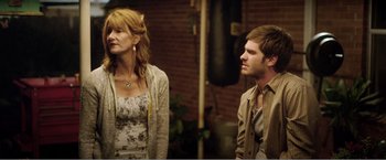 Movie still from “99 Homes” (2014), directed by Ramin Bahrani – A man and a woman standing next to each other; Medium shot, Over the shoulder angle